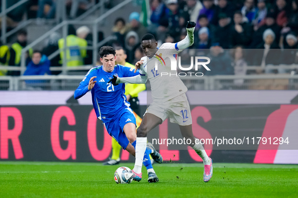 Alessandro Bastoni of Italy and Randal Kolo Muani of France compete for the ball during the UEFA Nations League 2024/25 League A Group 2 mat...