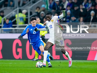 Alessandro Bastoni of Italy and Randal Kolo Muani of France compete for the ball during the UEFA Nations League 2024/25 League A Group 2 mat...