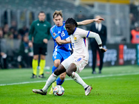 Nicolo' Barella of Italy and Manu Kone' of France compete for the ball during the UEFA Nations League 2024/25 League A Group 2 match between...