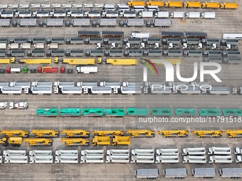 A large number of trucks and construction machinery gather at Yantai Port waiting for shipment for export in China's Shandong province, on N...