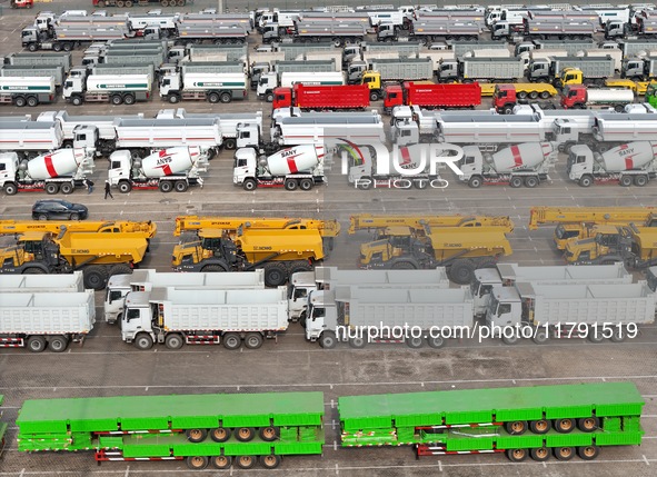 A large number of trucks and construction machinery gather at Yantai Port waiting for shipment for export in China's Shandong province, on N...