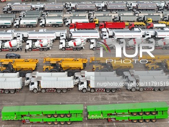 A large number of trucks and construction machinery gather at Yantai Port waiting for shipment for export in China's Shandong province, on N...