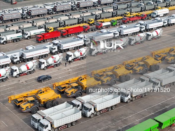 A large number of trucks and construction machinery gather at Yantai Port waiting for shipment for export in China's Shandong province, on N...