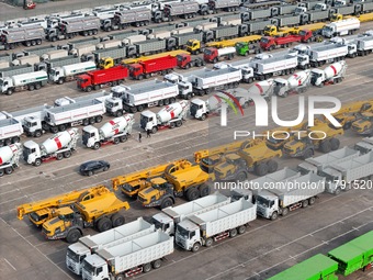 A large number of trucks and construction machinery gather at Yantai Port waiting for shipment for export in China's Shandong province, on N...