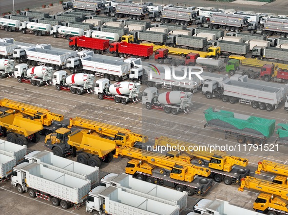 A large number of trucks and construction machinery gather at Yantai Port waiting for shipment for export in China's Shandong province, on N...