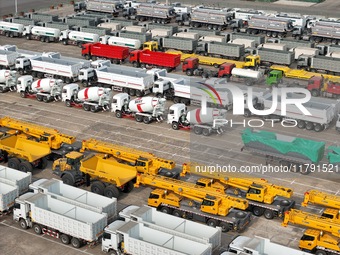 A large number of trucks and construction machinery gather at Yantai Port waiting for shipment for export in China's Shandong province, on N...