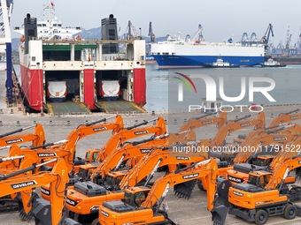 A large number of construction machines gather at Yantai Port, waiting for shipment for export in Yantai, China, on November 19, 2024. (