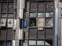 A Palestinian woman looks out from a building destroyed in previous airstrikes during the Israeli military offensive, amid the ongoing confl...