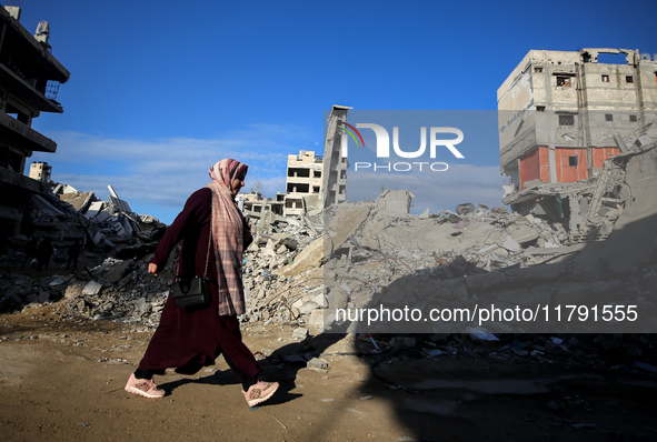 A Palestinian woman walks next to the rubble of a house destroyed in previous airstrikes during the Israeli military offensive, amid the ong...