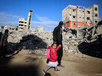 A Palestinian walks next to the rubble of a house destroyed in previous airstrikes during the Israeli military offensive, amid the ongoing c...