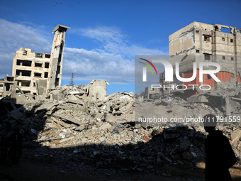 A Palestinian boy walks next to the rubble of a house destroyed in previous airstrikes during the Israeli military offensive, amid the ongoi...