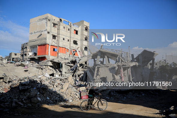 A Palestinian man walks next to the rubble of a house destroyed in previous airstrikes during the Israeli military offensive, amid the ongoi...