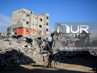 A Palestinian man walks next to the rubble of a house destroyed in previous airstrikes during the Israeli military offensive, amid the ongoi...