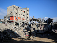 A Palestinian man walks next to the rubble of a house destroyed in previous airstrikes during the Israeli military offensive, amid the ongoi...