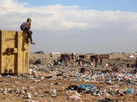 A Palestinian searches through a pile of garbage in Khan Yunis, Gaza Strip, on November 19, 2024, amid the ongoing war between Israel and th...