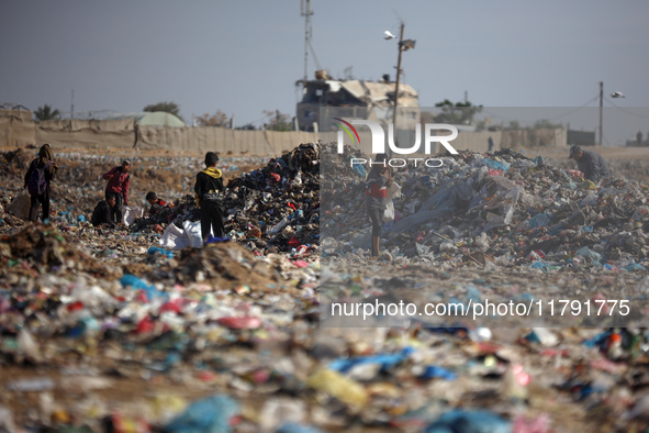 A Palestinian searches through a pile of garbage in Khan Yunis, Gaza Strip, on November 19, 2024, amid the ongoing war between Israel and th...