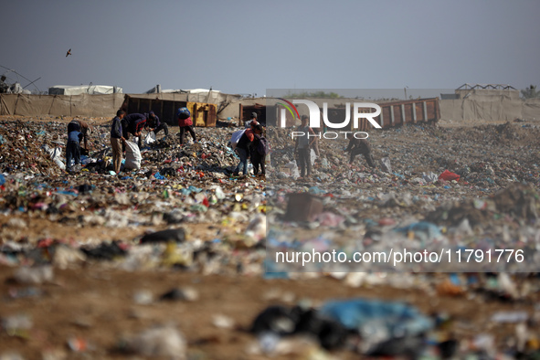 A Palestinian searches through a pile of garbage in Khan Yunis, Gaza Strip, on November 19, 2024, amid the ongoing war between Israel and th...