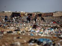 A Palestinian searches through a pile of garbage in Khan Yunis, Gaza Strip, on November 19, 2024, amid the ongoing war between Israel and th...