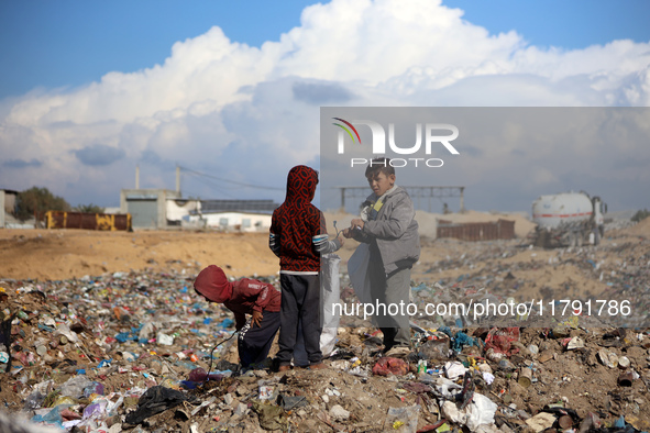 A Palestinian searches through a pile of garbage in Khan Yunis, Gaza Strip, on November 19, 2024, amid the ongoing war between Israel and th...