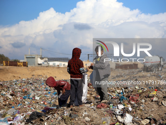 A Palestinian searches through a pile of garbage in Khan Yunis, Gaza Strip, on November 19, 2024, amid the ongoing war between Israel and th...