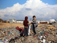 A Palestinian searches through a pile of garbage in Khan Yunis, Gaza Strip, on November 19, 2024, amid the ongoing war between Israel and th...