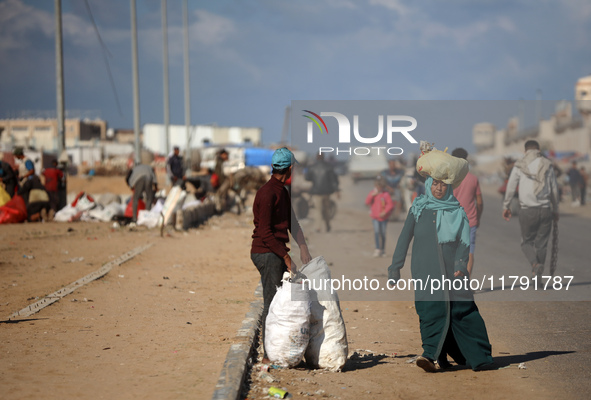 A Palestinian searches through a pile of garbage in Khan Yunis, Gaza Strip, on November 19, 2024, amid the ongoing war between Israel and th...