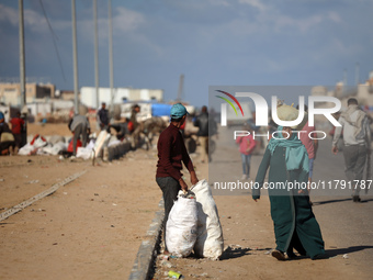 A Palestinian searches through a pile of garbage in Khan Yunis, Gaza Strip, on November 19, 2024, amid the ongoing war between Israel and th...