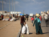 A Palestinian searches through a pile of garbage in Khan Yunis, Gaza Strip, on November 19, 2024, amid the ongoing war between Israel and th...