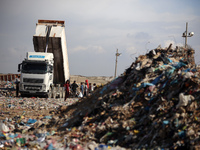 A Palestinian searches through a pile of garbage in Khan Yunis, Gaza Strip, on November 19, 2024, amid the ongoing war between Israel and th...