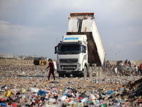 A Palestinian searches through a pile of garbage in Khan Yunis, Gaza Strip, on November 19, 2024, amid the ongoing war between Israel and th...