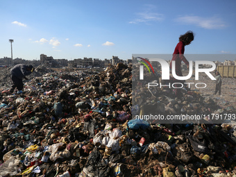 A Palestinian searches through a pile of garbage in Khan Yunis, Gaza Strip, on November 19, 2024, amid the ongoing war between Israel and th...