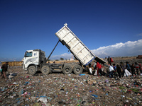 A Palestinian searches through a pile of garbage in Khan Yunis, Gaza Strip, on November 19, 2024, amid the ongoing war between Israel and th...