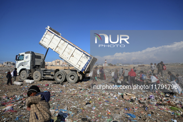 A Palestinian searches through a pile of garbage in Khan Yunis, Gaza Strip, on November 19, 2024, amid the ongoing war between Israel and th...