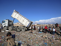 A Palestinian searches through a pile of garbage in Khan Yunis, Gaza Strip, on November 19, 2024, amid the ongoing war between Israel and th...