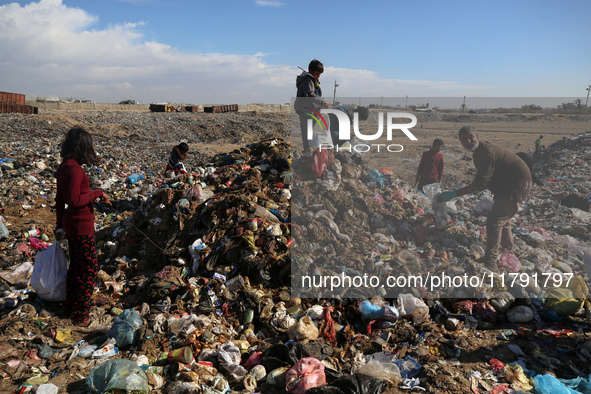 A Palestinian searches through a pile of garbage in Khan Yunis, Gaza Strip, on November 19, 2024, amid the ongoing war between Israel and th...