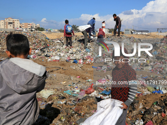 A Palestinian searches through a pile of garbage in Khan Yunis, Gaza Strip, on November 19, 2024, amid the ongoing war between Israel and th...