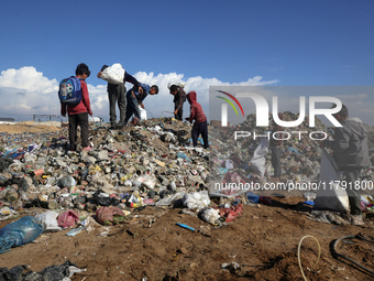 A Palestinian searches through a pile of garbage in Khan Yunis, Gaza Strip, on November 19, 2024, amid the ongoing war between Israel and th...