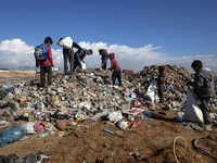 A Palestinian searches through a pile of garbage in Khan Yunis, Gaza Strip, on November 19, 2024, amid the ongoing war between Israel and th...