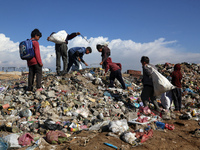 A Palestinian searches through a pile of garbage in Khan Yunis, Gaza Strip, on November 19, 2024, amid the ongoing war between Israel and th...