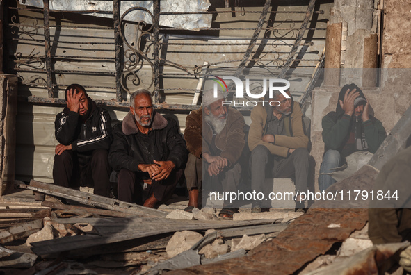 Displaced and local Palestinian residents of Khan Yunis wait outside a bakery for fresh bread in the southern Gaza Strip city on November 19...