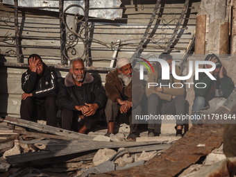 Displaced and local Palestinian residents of Khan Yunis wait outside a bakery for fresh bread in the southern Gaza Strip city on November 19...