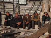 Displaced and local Palestinian residents of Khan Yunis wait outside a bakery for fresh bread in the southern Gaza Strip city on November 19...