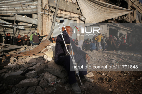 Displaced and local Palestinian residents of Khan Yunis wait outside a bakery for fresh bread in the southern Gaza Strip city on November 19...