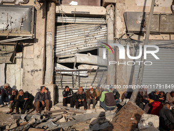 Displaced and local Palestinian residents of Khan Yunis wait outside a bakery for fresh bread in the southern Gaza Strip city on November 19...