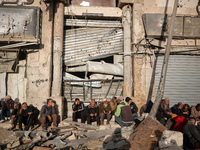 Displaced and local Palestinian residents of Khan Yunis wait outside a bakery for fresh bread in the southern Gaza Strip city on November 19...