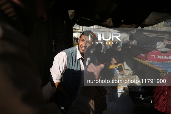 Palestinians wait for their falafel orders at a makeshift takeaway spot in Khan Yunis, Gaza Strip, on November 19, 2024, amid the ongoing wa...