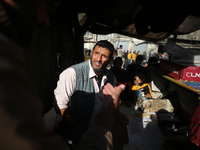 Palestinians wait for their falafel orders at a makeshift takeaway spot in Khan Yunis, Gaza Strip, on November 19, 2024, amid the ongoing wa...