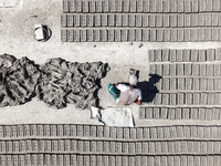 In Feni, Chittagong, Bangladesh, on November 19, 2024, workers mold hundreds of new bricks at a brick kiln. The daily laborers work from 8 a...