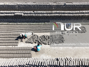 In Feni, Chittagong, Bangladesh, on November 19, 2024, workers mold hundreds of new bricks at a brick kiln. The daily laborers work from 8 a...