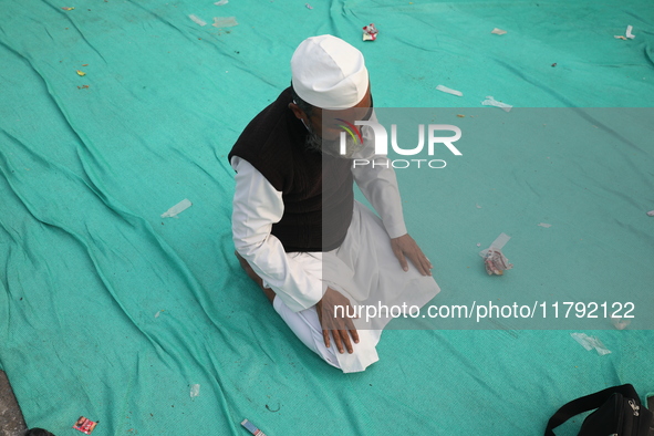 An activist of The All India Youth Federation (AIYF) offers a prayer after attending a protest meeting in Kolkata, India, on November 19, 20...